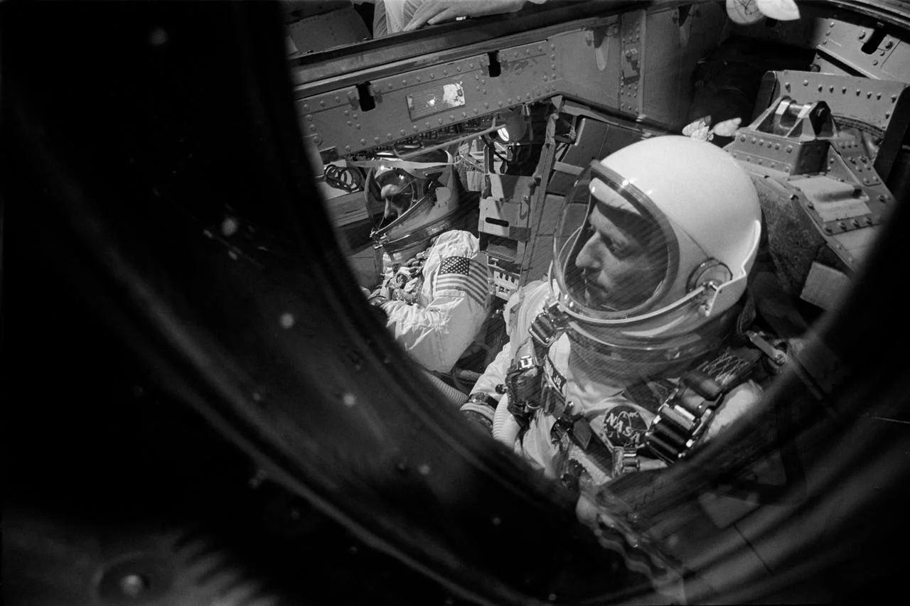 Pete Conrad and Richard Gordon strapped into Gemini XI, awaiting launch with their helmets on and harnesses secured.